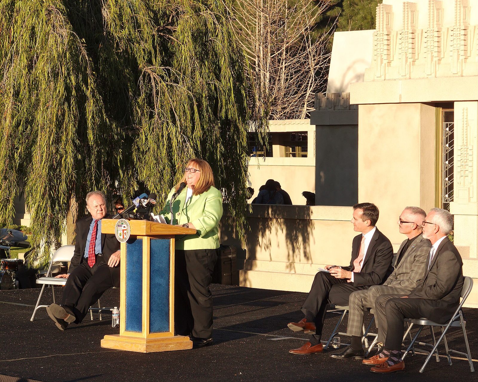 Ribbon-cutting ceremony with speakers and guests at the reopening of the restored house, February 2015